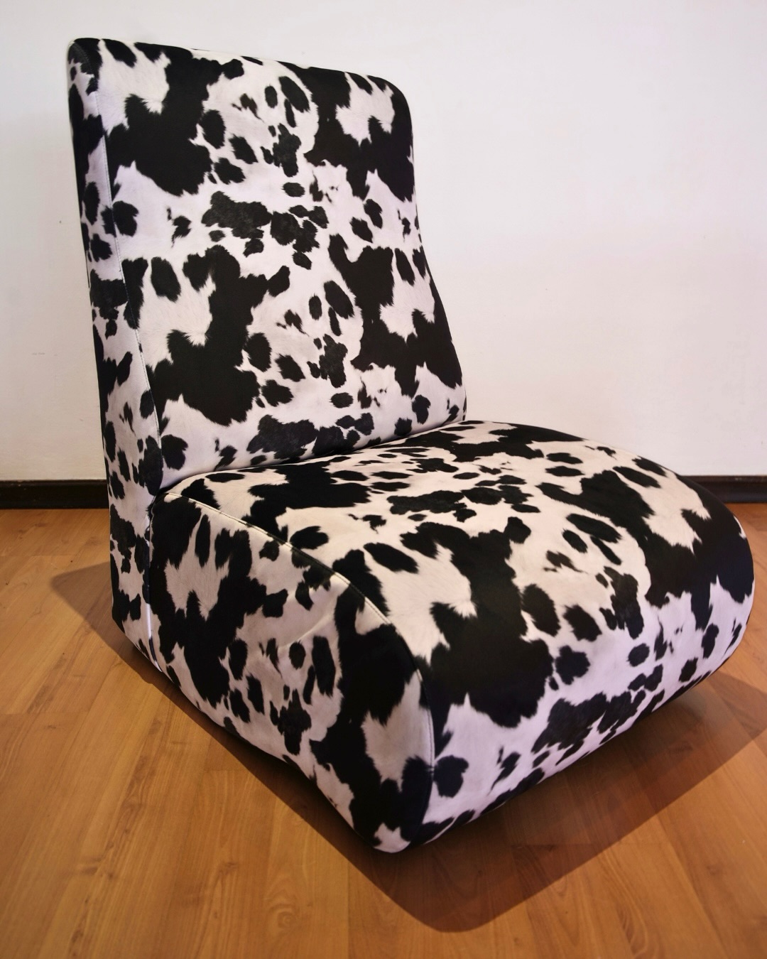 Slipper chair upholstered in black and white cowhide-print velvet