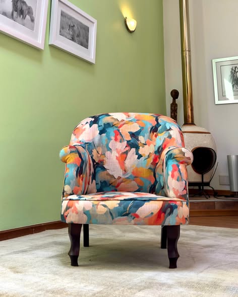 Tub chair upholstered in painterly abstract floral fabric in coral, teal and cream