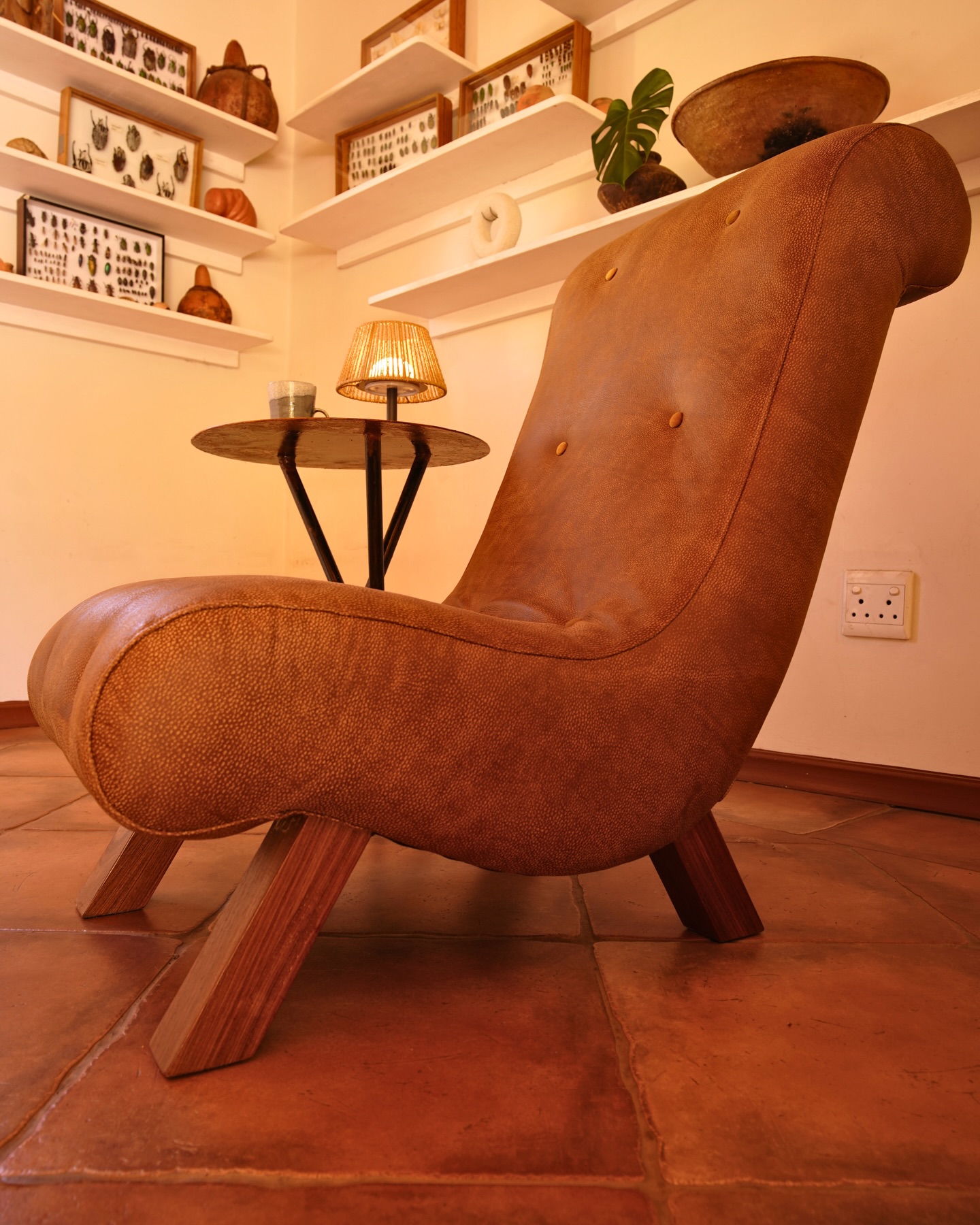 The Lounger — Carlo Upholstery's signature tan leather form with hardwood splayed legs