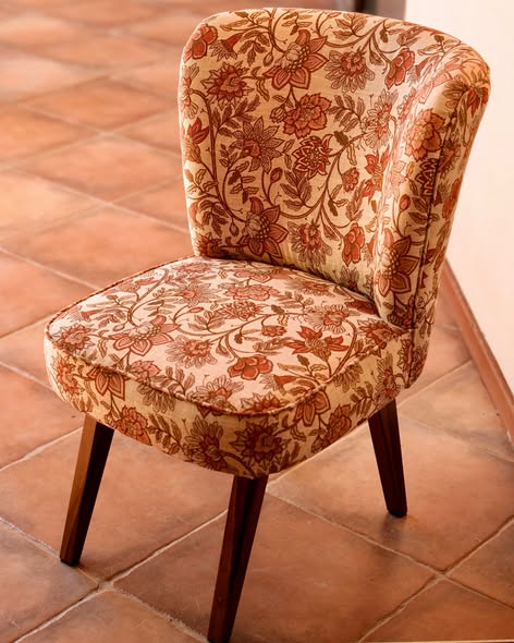Vintage occasional chair recovered in floral linen with tapered wooden legs